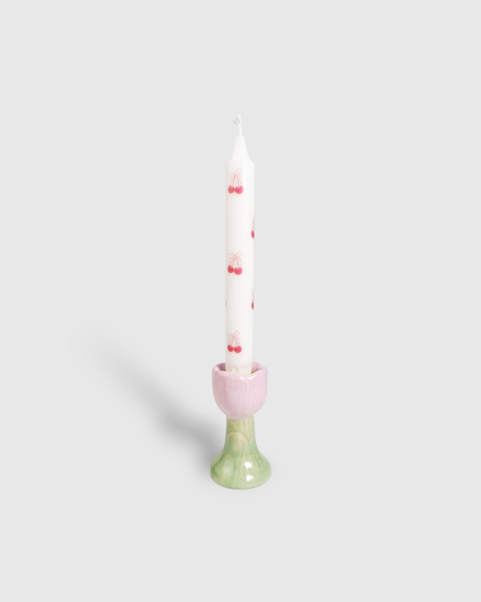 White dinner candle with red cherrie motifs