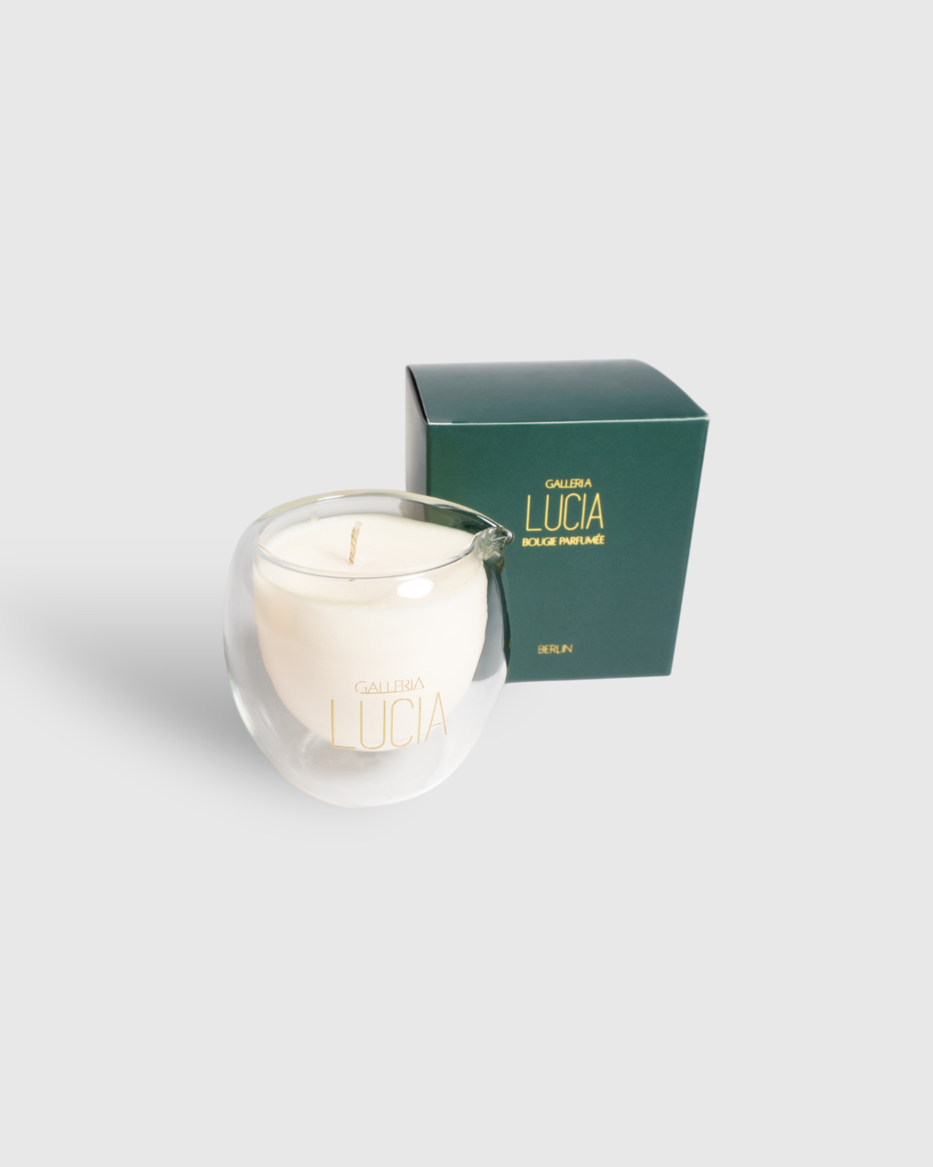 Massage candle with a gold label with a dark green gift box
