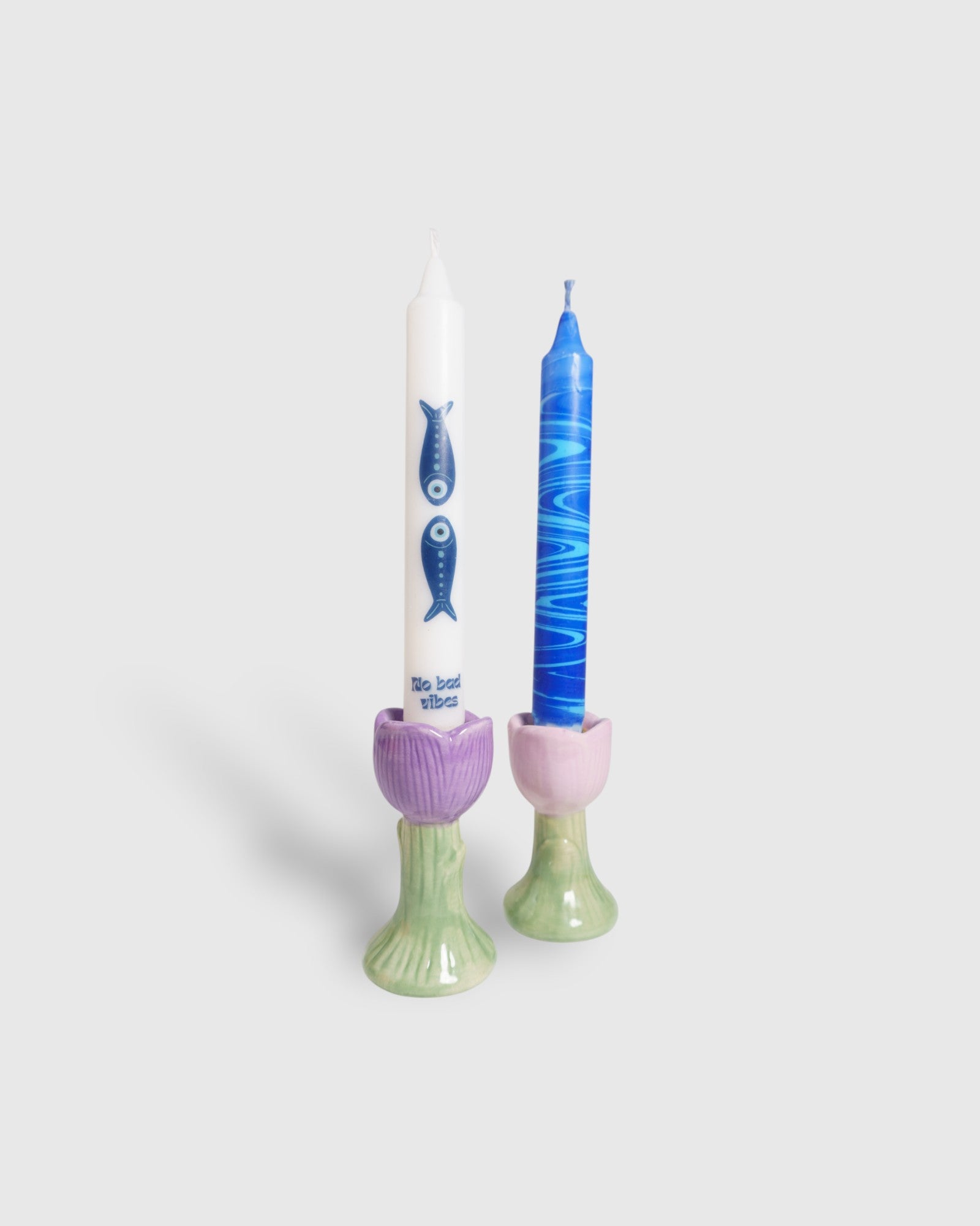 Evil fish and blue marble taper candles in candle holders